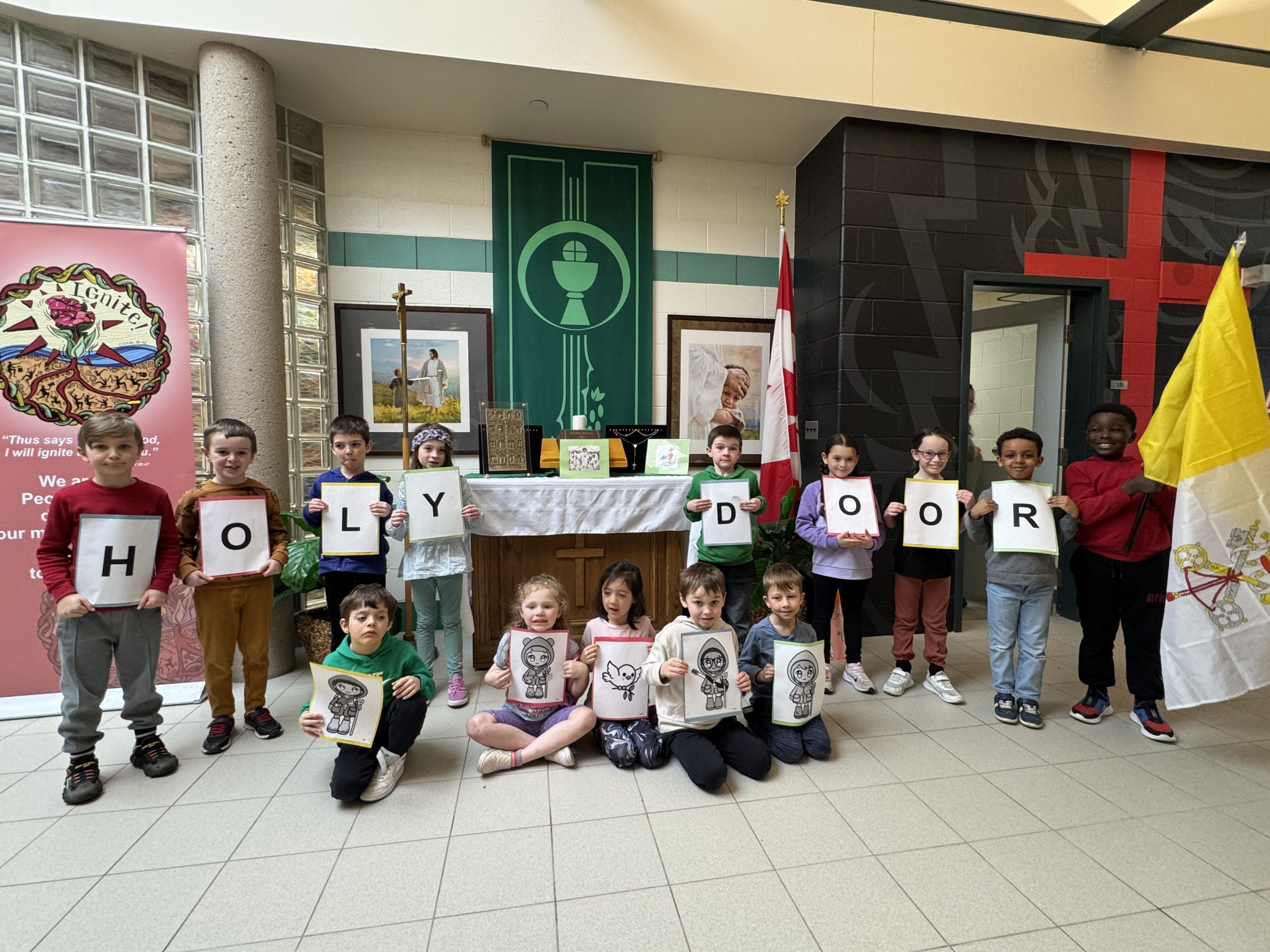 Students with Holy Door and holding up letters to spell out Holy Door