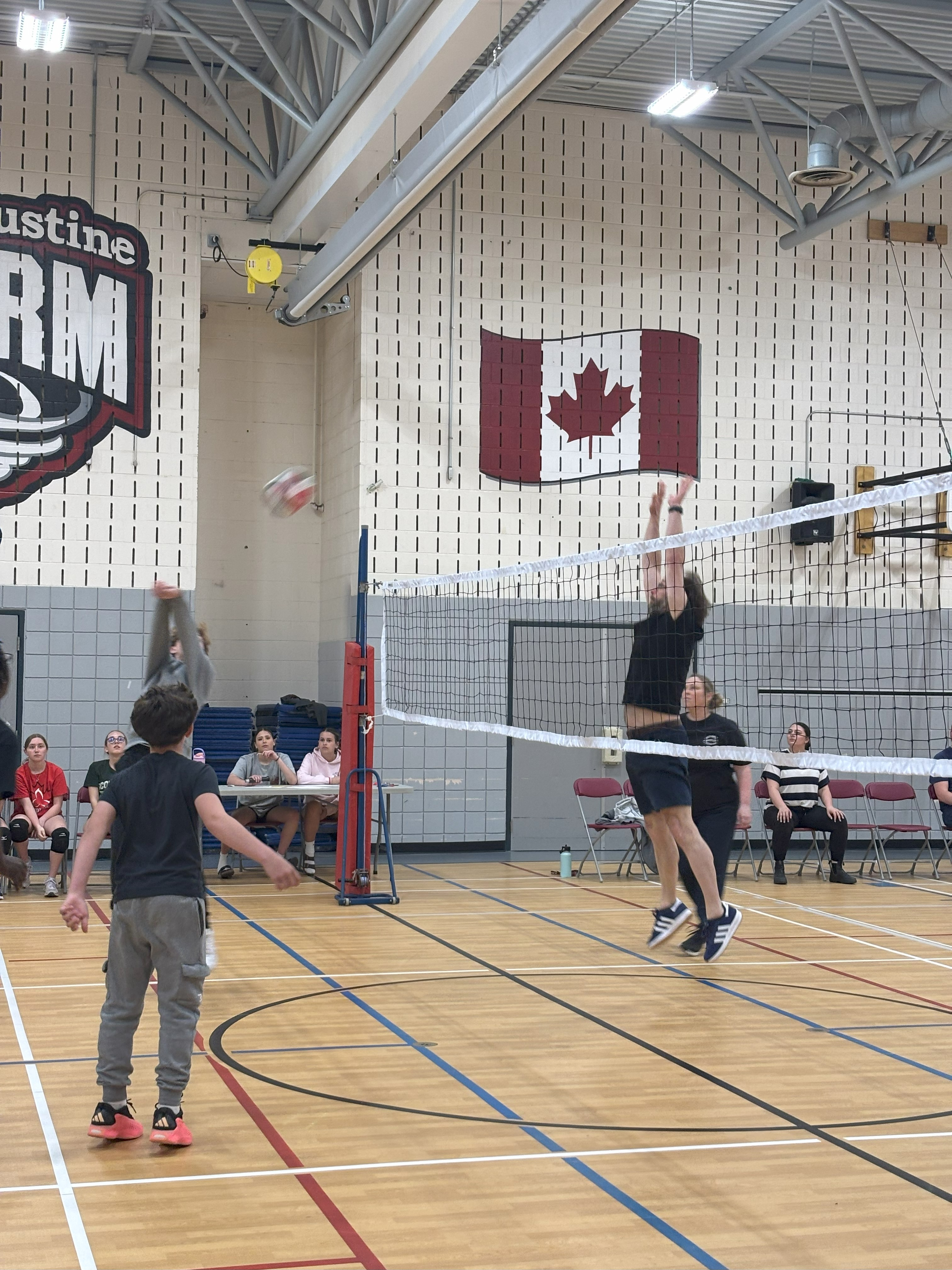 A teacher at St. Augustine blocking a volleyball