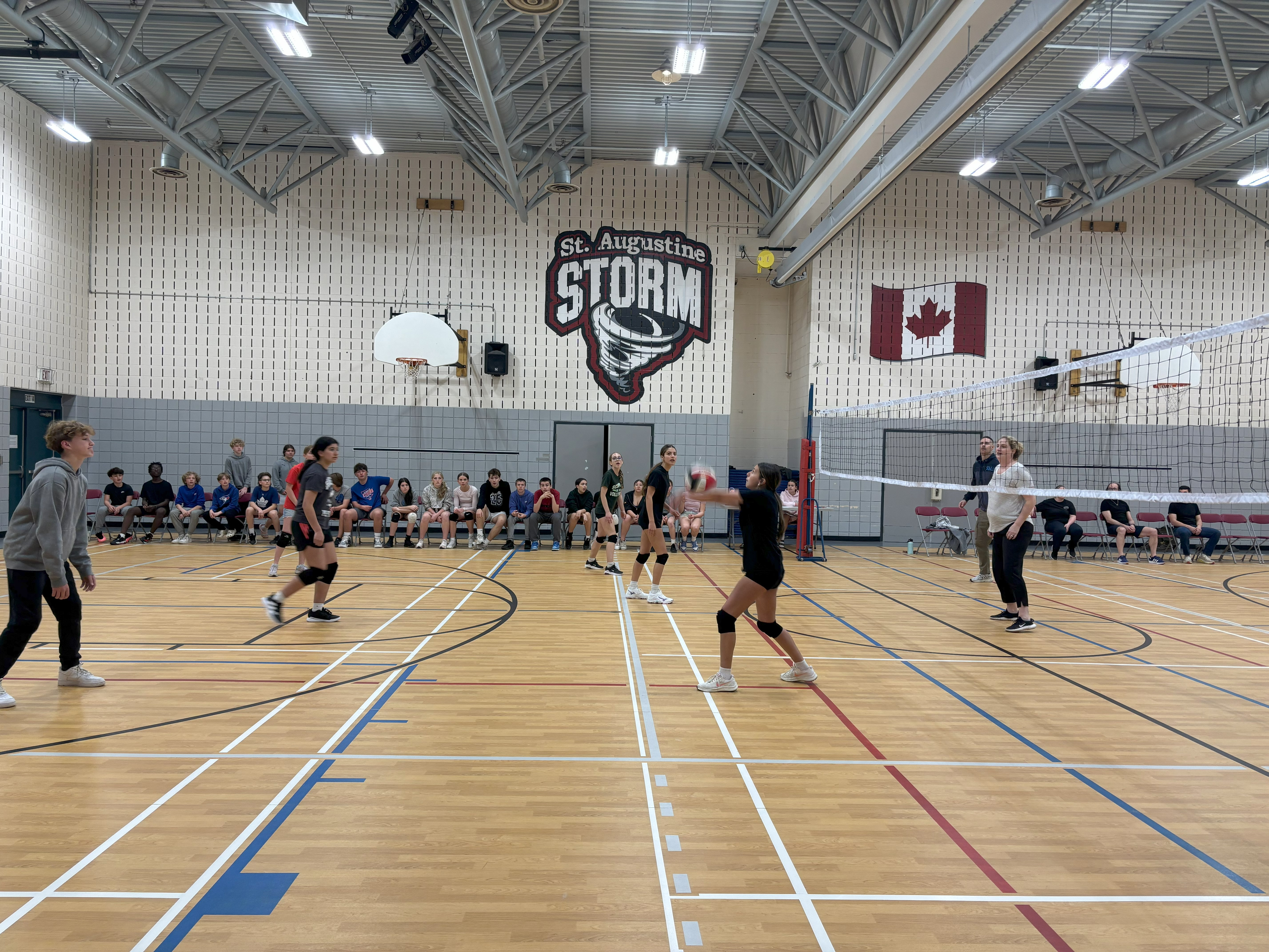 Students at St. Augustine playing a volleyball game against teachers