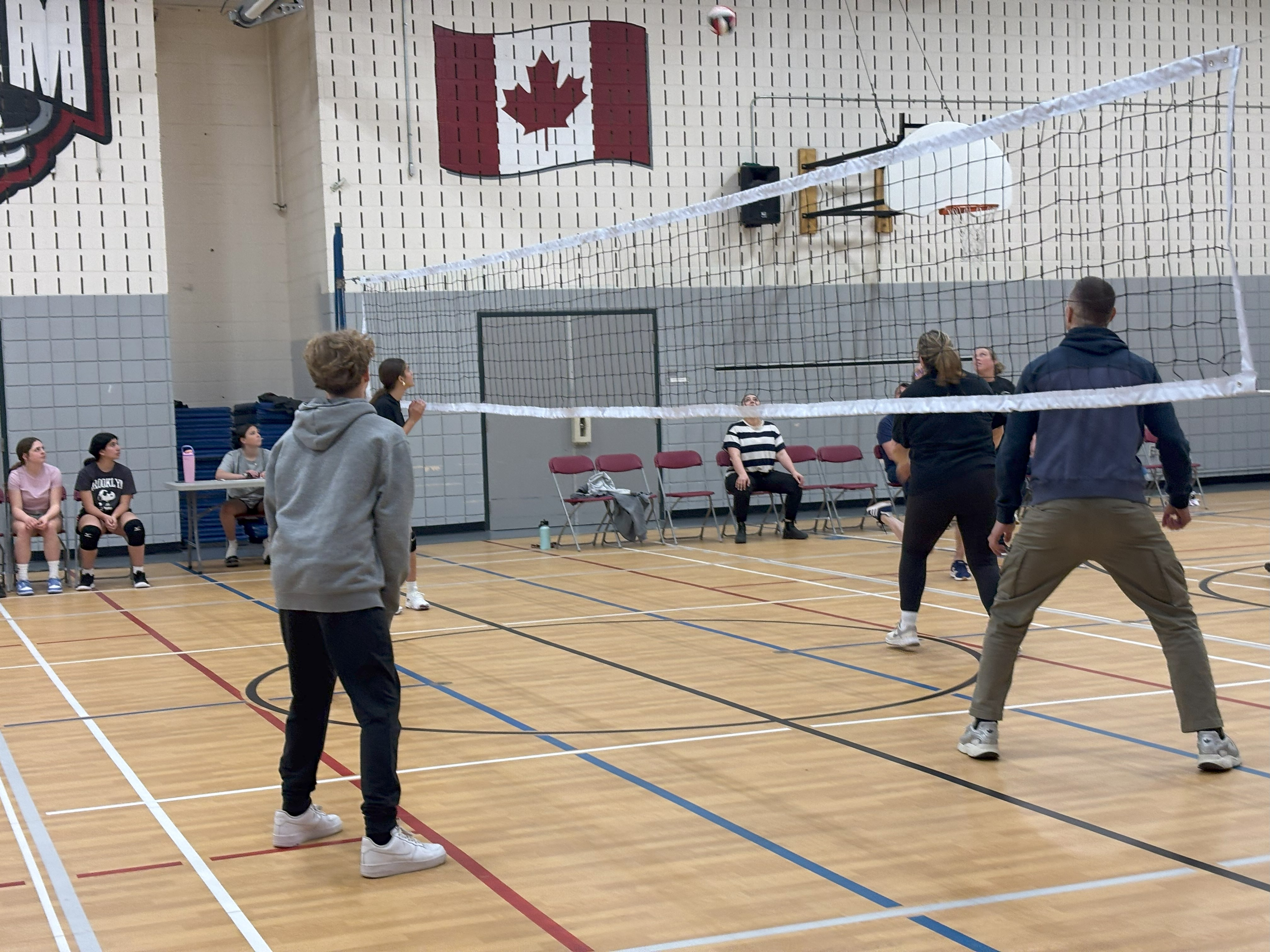 Teachers and students at St. Augustine playing a volleyball game