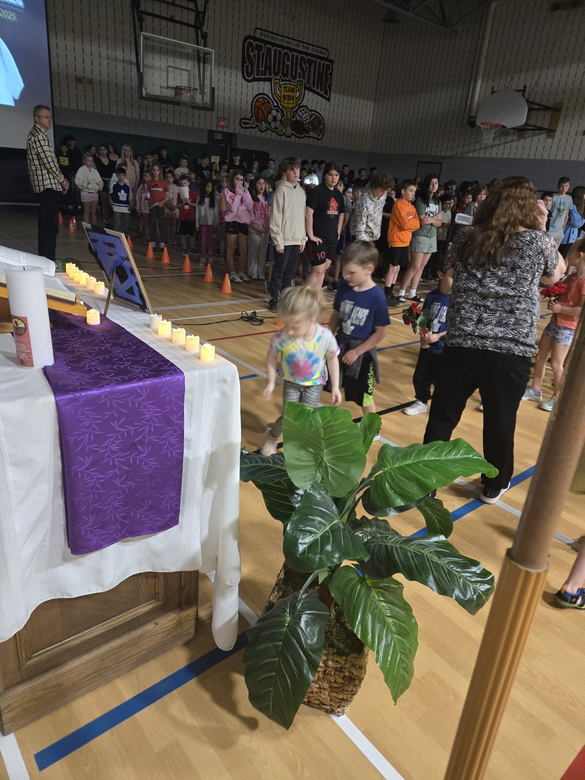Group of students laying flowers in front of altar