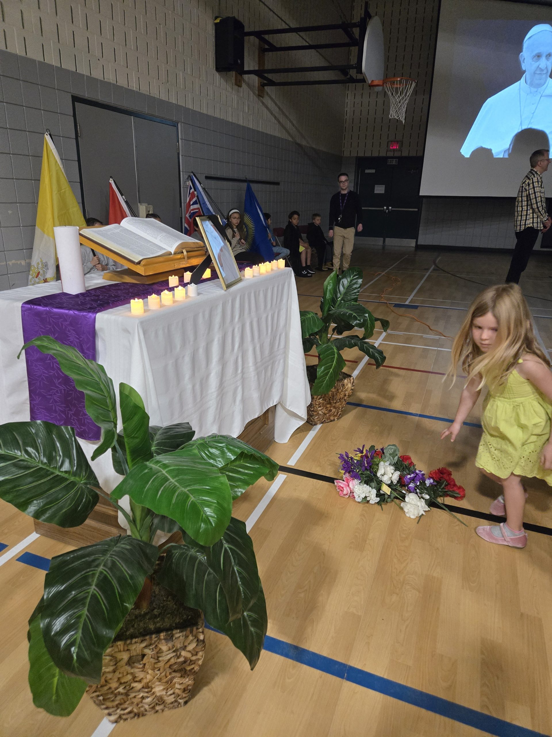 St. Augustine student laying flower in front of altar
